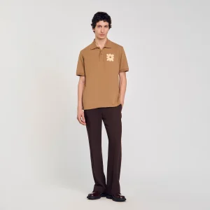 Polo con parche de flor